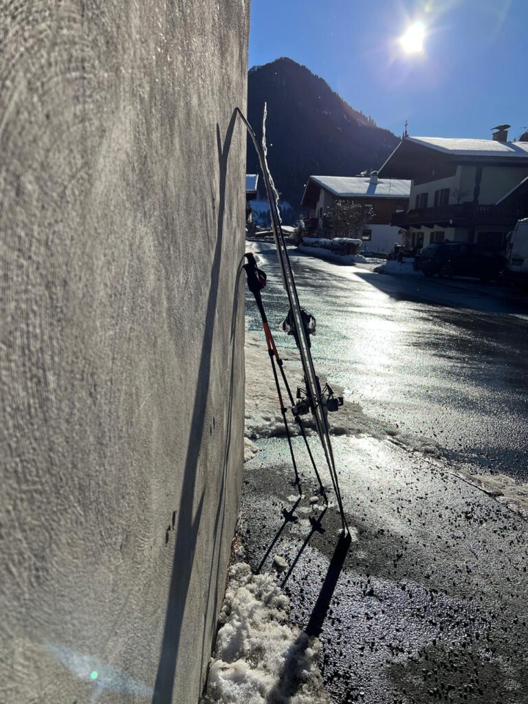 Aschau bei Kirchberg. Tourenski lehnen an der Bushaltestelle. Mit den öffentlichen Verkehrsmitteln zur Skitour.